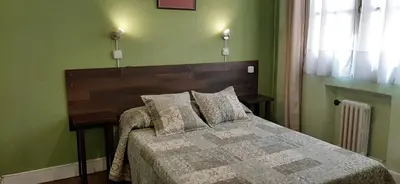 Cama o camas de una habitación en Hostal San Martin