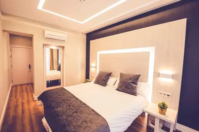 Cama o camas de una habitación en Hostal Lisboa