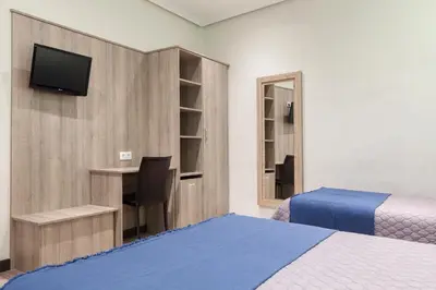 Cama o camas de una habitación en Hostal María Luisa