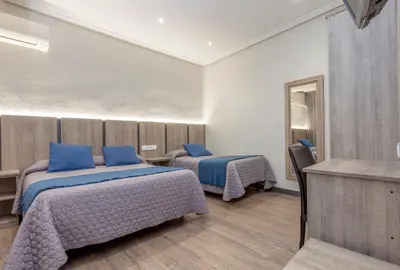 Cama o camas de una habitación en Hostal María Luisa
