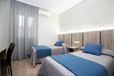 Cama o camas de una habitación en Hostal María Luisa