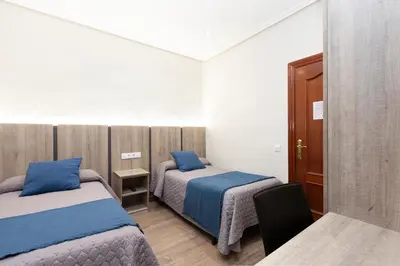 Cama o camas de una habitación en Hostal María Luisa