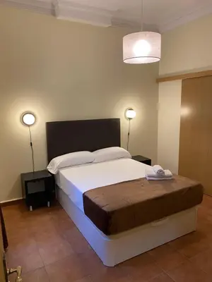 Cama o camas de una habitación en Hostal Alaska