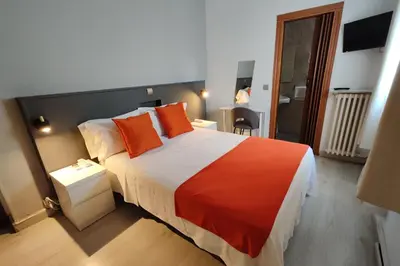 Cama o camas de una habitación en Hostal Cervantes