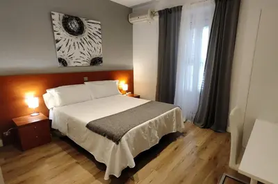 Cama o camas de una habitación en Hostal Cervantes