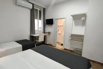 Cama o camas de una habitación en Hostal Cervantes