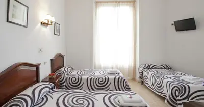 Cama o camas de una habitación en Hostal Condestable