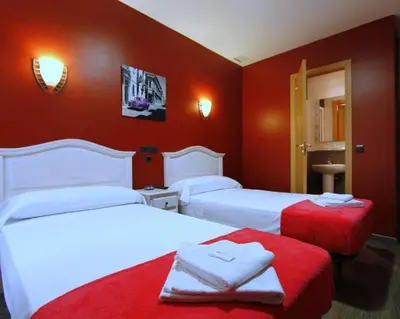 Cama o camas de una habitación en Hostal Regio