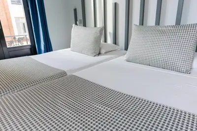 Cama o camas de una habitación en Hostal Carmen-Gran Vía