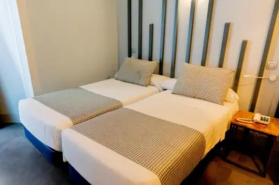 Cama o camas de una habitación en Hostal Carmen-Gran Vía