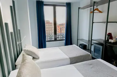 Cama o camas de una habitación en Hostal Carmen-Gran Vía