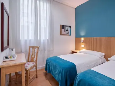 Cama o camas de una habitación en Hostal Bianco