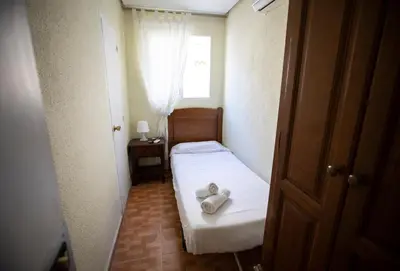 Cama o camas de una habitación en Hostal Los Perales