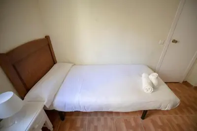 Cama o camas de una habitación en Hostal Los Perales