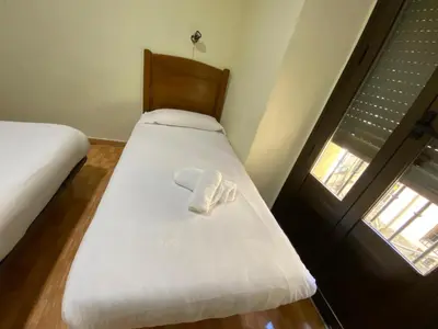 Cama o camas de una habitación en Hostal Los Perales