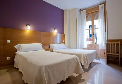 Cama o camas de una habitación en Hostal Zabala
