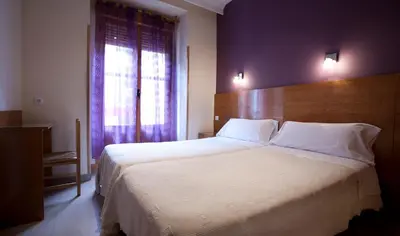 Cama o camas de una habitación en Hostal Zabala