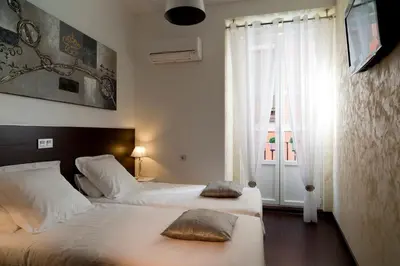 Cama o camas de una habitación en THC Latina Hostel