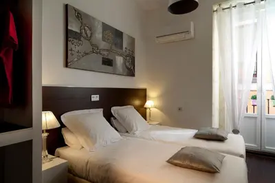 Cama o camas de una habitación en THC Latina Hostel
