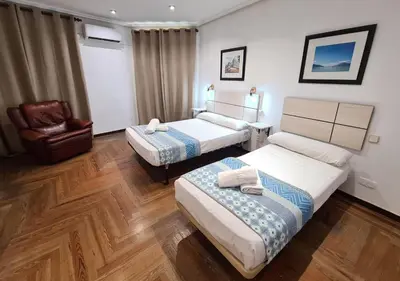 Cama o camas de una habitación en Hostal Santa Barbara