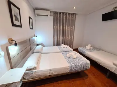 Cama o camas de una habitación en Hostal Santa Barbara
