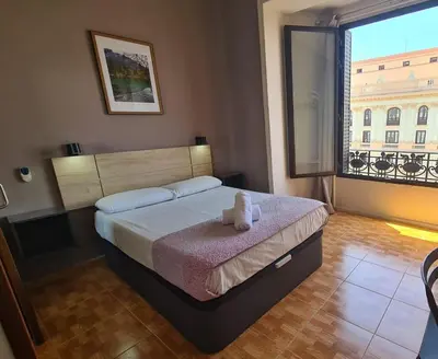 Cama o camas de una habitación en Hostal Miami