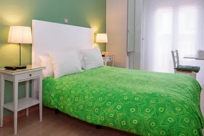 Cama o camas de una habitación en Hostal Adriano