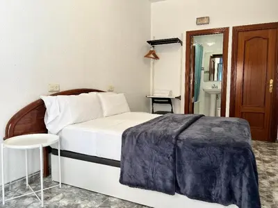 Cama o camas de una habitación en Hostal Palacios Fuencarral
