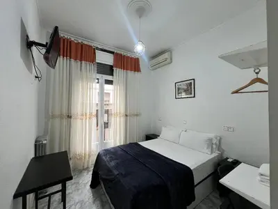 Cama o camas de una habitación en Hostal Palacios Fuencarral