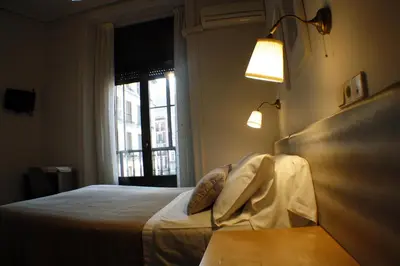 Cama o camas de una habitación en Hostal Santa Cruz