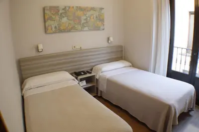 Cama o camas de una habitación en Hostal Santa Cruz