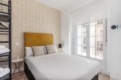 Cama o camas de una habitación en Waou Chueca I - Alquiler Corta Duración
