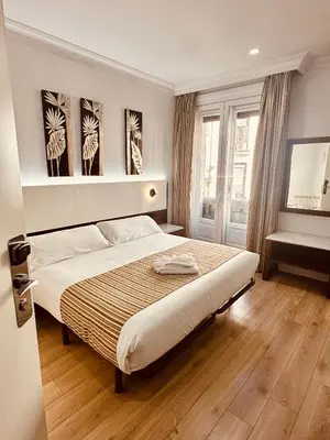 Cama o camas de una habitación en Hostal Abadia Madrid