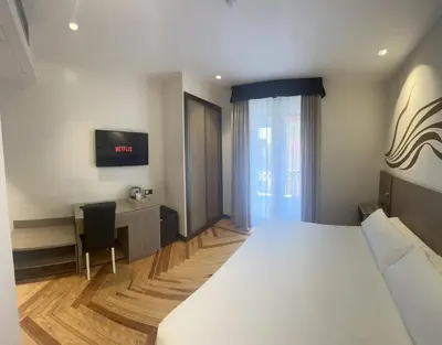 Cama o camas de una habitación en Hostal Abadia Madrid