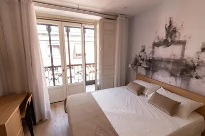 Cama o camas de una habitación en Plaza Mayor Suites & Apartments