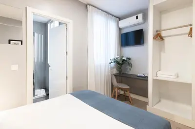 Cama o camas de una habitación en 8Rooms Madrid