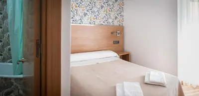 Cama o camas de una habitación en Hostal San Antonio