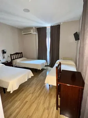 Cama o camas de una habitación en Hostal Río Paraná