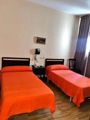 Cama o camas de una habitación en Hostal Río Paraná