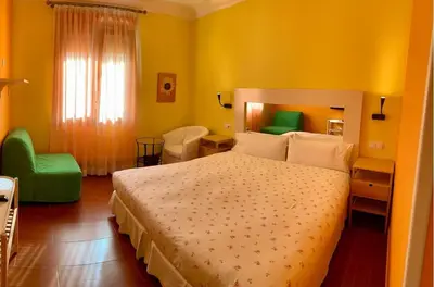 Cama o camas de una habitación en Hostal Arco Iris