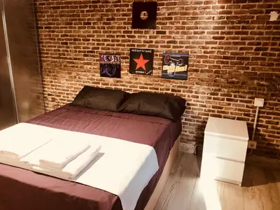 Cama o camas de una habitación en Gran Vía apartamentos de temporada