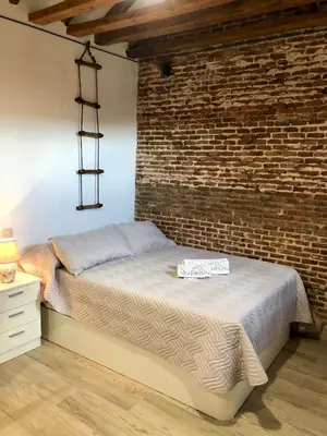 Cama o camas de una habitación en Gran Vía apartamentos de temporada