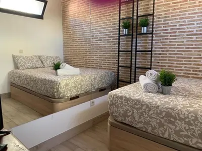 Cama o camas de una habitación en Gran Vía apartamentos de temporada