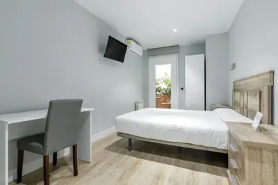 Cama o camas de una habitación en Hostal Los Ángeles
