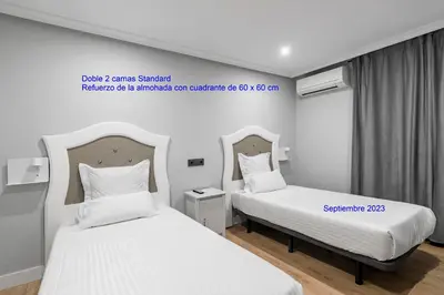 Cama o camas de una habitación en Hostal Los Ángeles