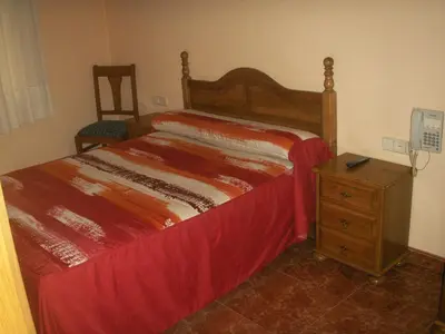 Cama o camas de una habitación en Hostal La Nava