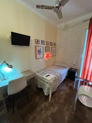 Cama o camas de una habitación en Casa de Huespedes Dolce Vita