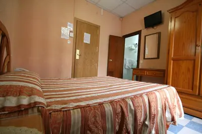 Cama o camas de una habitación en Hostal La Perla Asturiana