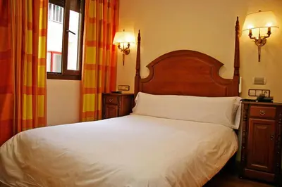 Cama o camas de una habitación en Hostal Victoria I