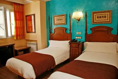 Cama o camas de una habitación en Hostal Victoria I